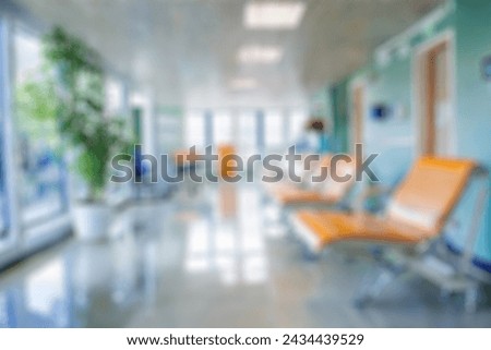 blurred of background. interior of a modern hospital with an empty long corridor. waiting room for patients and families between the corridor with bright white lights. treatment rooms and patient room Royalty-Free Stock Photo #2434439529