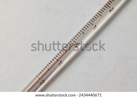 Close-up of mercury thermometer on white background Royalty-Free Stock Photo #2434440671