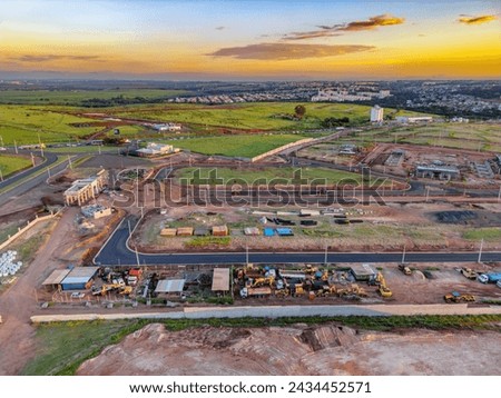 Aerial image of the city of Paulínia during sunset with traffic and construction of a residential condominium. 2024.