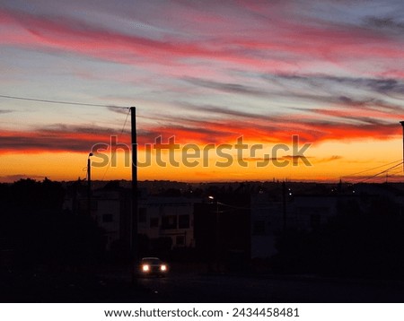  orange sky suntset picture an orange and yellow sunset in the dark sky over a small town located in morocco 
