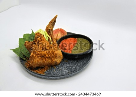 Ayam Goreng Kalasan, Indonesian food from Kalasan, Yogyakarta. It's fried chicken that cooked with special spice, combined with 'kremes', a crispy fried flour. Selective Focus