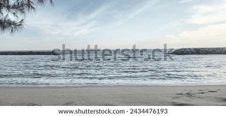 View beach and blue sky, and rocks on the beach dark mode.