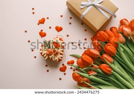 Birthday cake, bouquet of red tulips and envelope with letter, holiday gift.