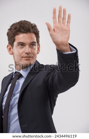 Businessman, palm and hand with touch for interaction, virtual display or connection on a gray studio background. Isolated young man, user or business employee showing gesture sign, symbol or wait