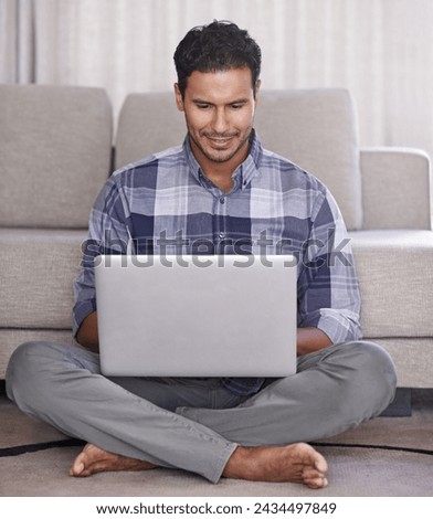 Man, student and internet for laptop on floor of living room, education and scroll or browse on website. Male person, happy and online for information or home for app, sitting and elearning on tech