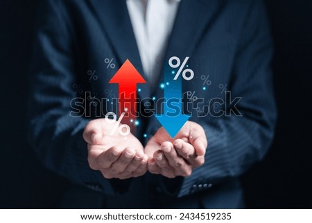 Financial interest rate and mortgage rate concept, interest rates stocks, Finance ratings. Businessman hold up and down arrow icons with percentage icon for graph indicators.