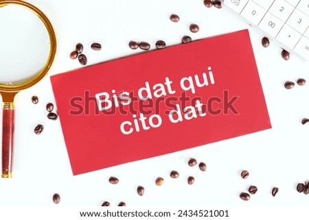 Bis dat qui cito dat It is translated from Latin as The one who gives twice is the one who gives quickly It's written on the red card