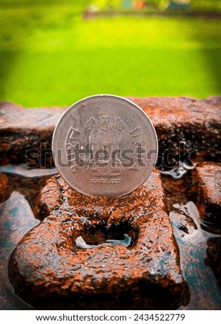 After raining I thought an incredible idea. I stand a coin on brick which full with rain drops and then took a beautiful picture also edited it by Lightroom without any premium features. You can buy.