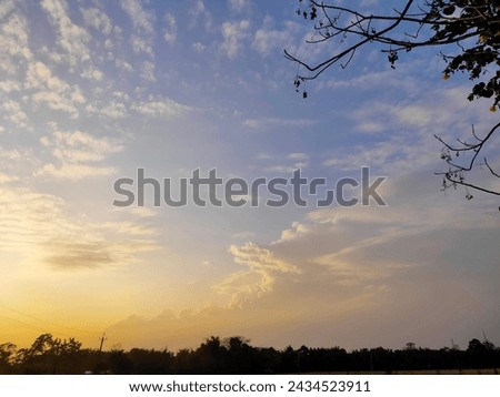 Picture of a beautiful blue sky with yellowish clouds 