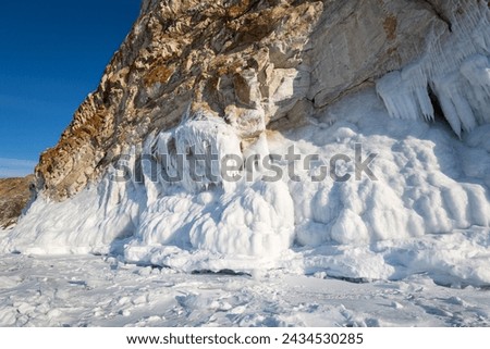 Coast of lake Baikal in winter, the deepest and largest freshwater lake by volume in the world, located in southern Siberia, Russia Royalty-Free Stock Photo #2434530285