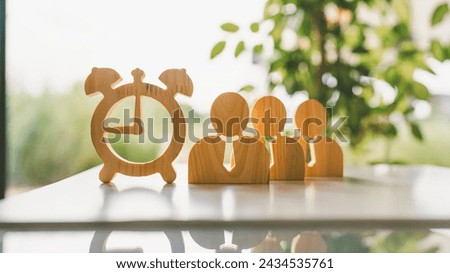 The office worker model and the wooden clock model are ideas about time management in business work.