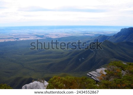 Photo of a mountain range and surrounding areas in Western Australia on a cloudy afternoon