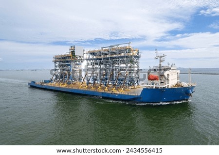 Top view Logistics and transportation large cargo ship Transporting loads of oil rig parts  Oversized cargo transportation  Royalty-Free Stock Photo #2434556415