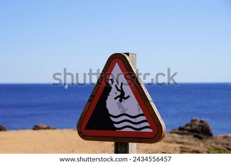 Signroad man falling from a height danger of falling from a cliff sea coast ocean