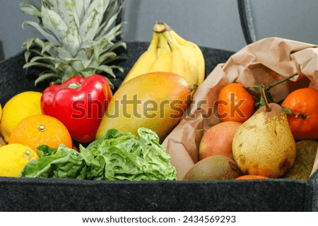 Close up of eco fruits and vegetables in a eco felt bag Royalty-Free Stock Photo #2434569293