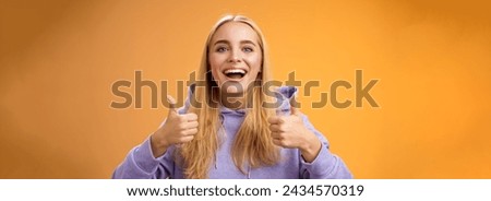 Supportive cute blond girlfriend cheering liking interesting concept cool idea thumbs-up smiling broadly agree approve outfit shopping together friends, recommend adore new look, orange background. Royalty-Free Stock Photo #2434570319