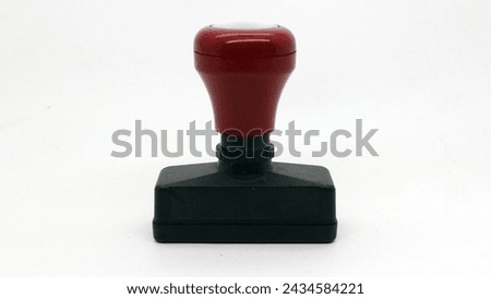 Black wooden rubber stamp isolated on white background Royalty-Free Stock Photo #2434584221