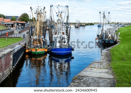 Fish boats in the Small idyllic harbor of Greetsiel-Krummhörn, north sea, Germany Royalty-Free Stock Photo #2434600945