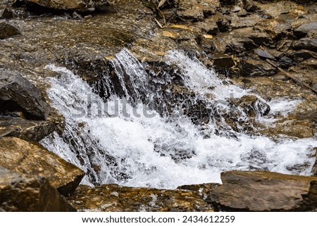 small waterfall with a small lake near Bhimtal. Landscape view of a small waterfall in the mountains. crystalline waterfall.
 Royalty-Free Stock Photo #2434612259