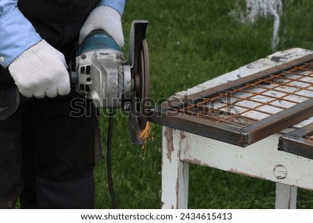 Removal of metal in places of electric welding with a flap disc for an angle grinder Royalty-Free Stock Photo #2434615413