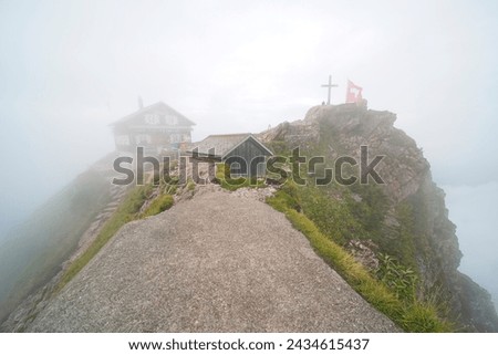 On the summit of the "Grossen mythen". The mountain is in Switzerland in the canton of Schwyz and is 1898m high. In the picture you can see the mountain restaurant on a foggy day.