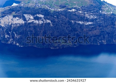 Aerial view of Lake Lucerne with Rütli meadow and mountain village Seelisberg on a sunny winter day seen from Fronalpstock mountain. Photo taken February 13th, 2024, Fronalpstock, Stoos, Switzerland.