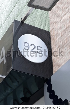 Modern Illuminated Street Number '925' on Entrance of Building  Royalty-Free Stock Photo #2434640159