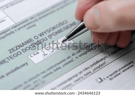 Complete the Polish tax return on your income and submit it to the tax office  translation: example Polish tax form - declaration of income Royalty-Free Stock Photo #2434646123