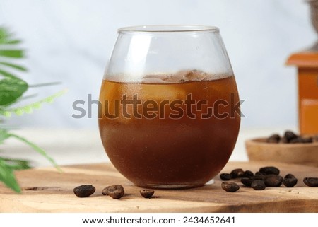 Iced Coffee in a Glass With Ice Cubes  on Wooden Board,White Background