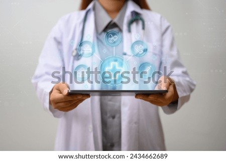 Doctor holding digital tablet with medical icons on digital virtual interface. Innovation and medical technology