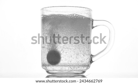 Effervescent tablet dissolve with bubbles in a glass of water