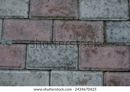 Pavement made of concrete tiles viewed from above as full frame texture, background.