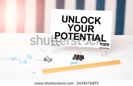 Unlock Your Potential sign held by clips on striped background