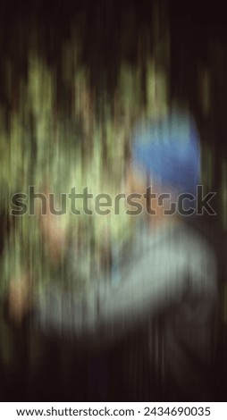 A detective or police man finding a clue in the place of murder. Motion blurred image