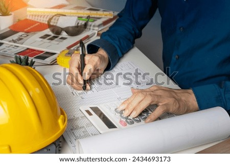 Engineers sit and work on building design and system work.,construction work safety,construction business and real estate Royalty-Free Stock Photo #2434693173