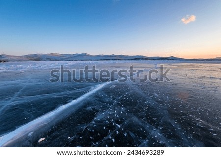 Ice of Lake Baikal, the deepest and largest freshwater lake by volume in the world, located in southern Siberia, Russia Royalty-Free Stock Photo #2434693289