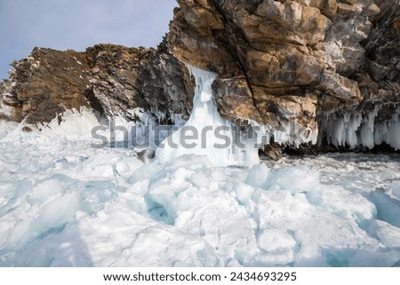 Coast of lake Baikal in winter, the deepest and largest freshwater lake by volume in the world, located in southern Siberia, Russia Royalty-Free Stock Photo #2434693295
