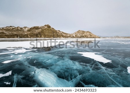 Lake Baikal in winter, the deepest and largest freshwater lake by volume in the world, located in southern Siberia, Russia Royalty-Free Stock Photo #2434693323