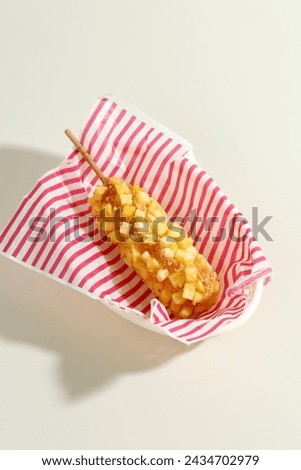Delicious Crunchy Korean Style Chunky Potato Corn Dogs with Batter and Cubed Fried Potatoes. Royalty-Free Stock Photo #2434702979