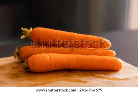 fresh carrots on wooden board close-up