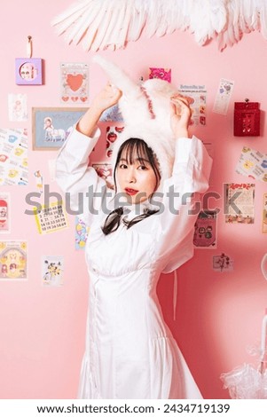 Woman portrait in pink and colorful room.