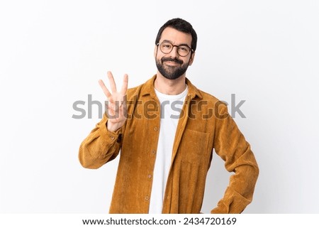 Caucasian handsome man with beard wearing a corduroy jacket over isolated white background happy and counting three with fingers