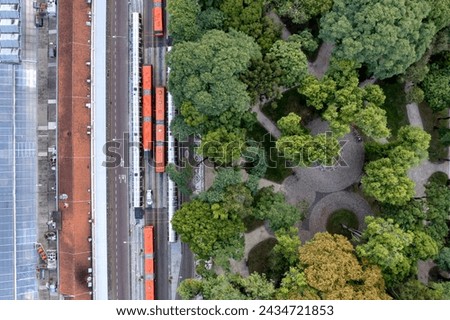 Aerial view of Curitiba, Brazil, and its buses and tube stops, and a verdant green park Royalty-Free Stock Photo #2434721853