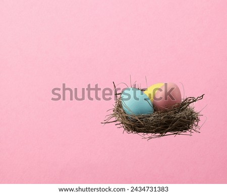 Easter egg with beautiful spring flowers on pink background. Easter spring concept with copy space