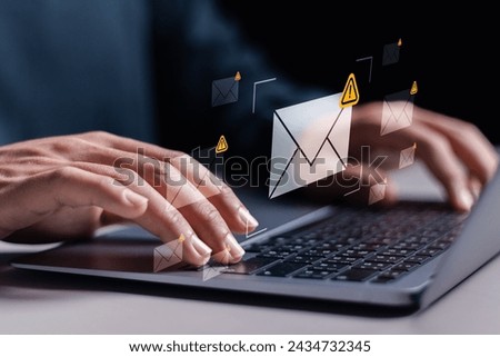 Email Spam concept. warning notification and spam message. Person using laptop with Spam email notification on  virtual screen.