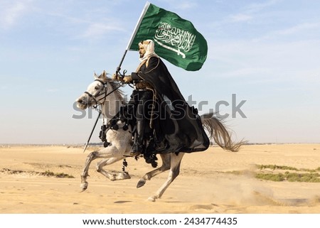 Man in traditional clothing with his horse in a desert Royalty-Free Stock Photo #2434774435