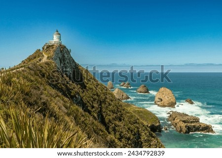 The 10-metre Nugget Point lighthouse, off the Southern Scenic Route, was first lit in 1870. Surrounded by rocky islets or nuggets, it was was automated in 1988.
 Royalty-Free Stock Photo #2434792839