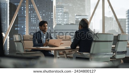 South Asians Business Partners Striking a Successful Deal at a Corporate Modern Meeting Room. Two Young Indian Businessmen Discussing Investment Opportunities, Strategy, Financing. Royalty-Free Stock Photo #2434800127