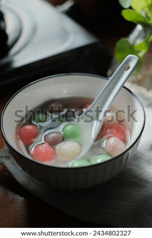 Tang Yuan is a Chinese dessert made of glutinous rice flour balls served in sweet soup. It's enjoyed during festivals like the Winter Solstice. Selective focus Royalty-Free Stock Photo #2434802327