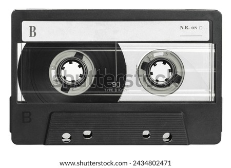 Classic black audio cassette tape with a blank label, isolated on a white background